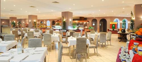 a dining room with white tables and chairs at Djerba Resort- Families and Couples Only in Houmt Souk