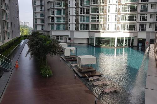a large building with a swimming pool in front of it at Homestay Kuala Lumpur ; Terminal TBS ; Bukit Jalil in Kuala Lumpur