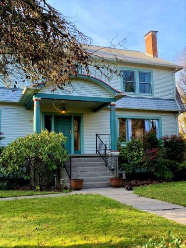 a blue house with a blue door and stairs at Riverpath Inn in Eugene
