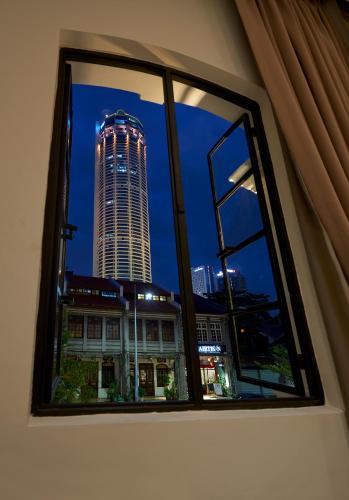 a view of a tall building from a window at Macalister Terraces Hotel in George Town