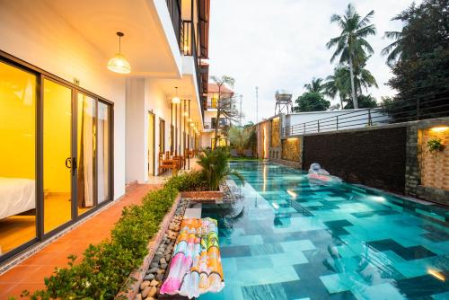 a swimming pool on the side of a building at Aurora House in Phu Quoc
