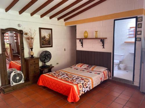 a bedroom with a bed and a bathroom at Apartasol En San Jeronimo in San Jerónimo