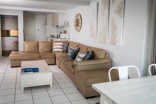 a living room with a couch and a table at White Waves on the Beach in Hastings Point