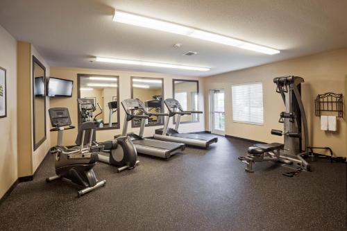 a gym with treadmills and machines in a room at Candlewood Suites Oklahoma City - Bricktown by IHG in Oklahoma City