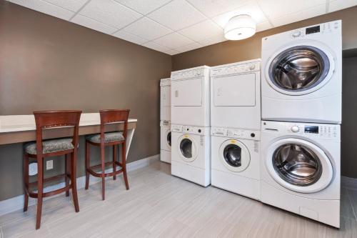 a laundry room with two washer and dryer at Staybridge Suites Kalamazoo by IHG in Kalamazoo
