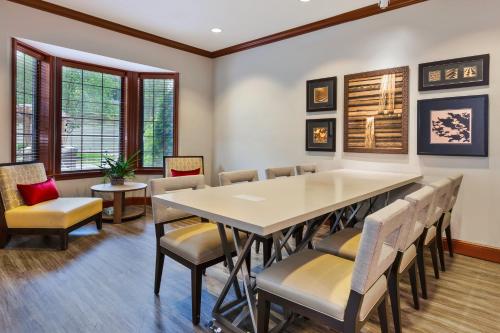 a dining room with a table and chairs at Staybridge Suites Kalamazoo by IHG in Kalamazoo