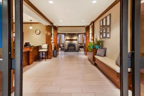 a hallway with a living room and a fireplace at Staybridge Suites Kalamazoo by IHG in Kalamazoo