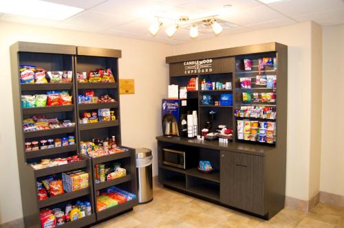a store with two shelves with food and drinks at Candlewood Victoria by IHG in Victoria
