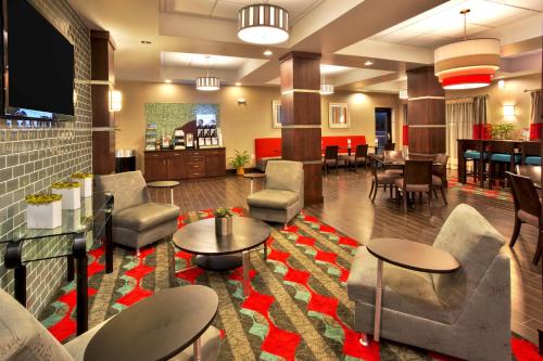 a lobby of a hotel with tables and chairs at Holiday Inn Express & Suites Oak Ridge, an IHG Hotel in Oak Ridge