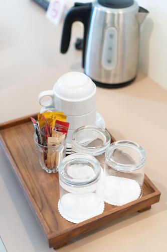 a wooden tray with bowls and utensils on a counter at Sino Mansion in Ranong