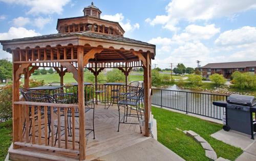a wooden gazebo with chairs and a grill at Candlewood Suites Springfield by IHG in Springfield
