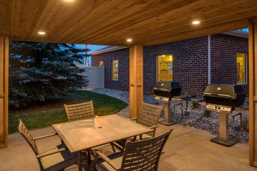 a patio with a table and two bbqs at Staybridge Suites Sioux Falls at Empire Mall by IHG in Sioux Falls