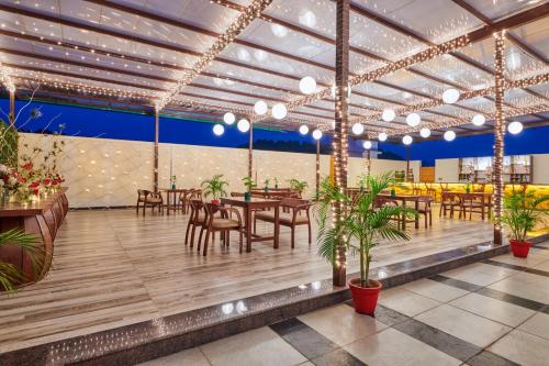 a restaurant with tables and chairs and lights at LP Vilas in Dehradun