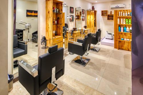 a hair salon with a bunch of barber chairs at LP Vilas in Dehradun