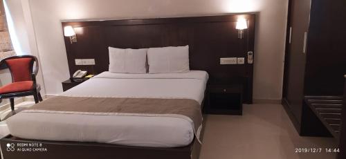 a bedroom with a large bed in a hotel room at The Curzon Court in Bengaluru