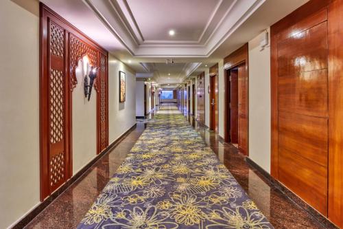 a corridor in a hotel with a carpet at LP Vilas in Dehradun