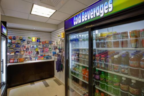 a grocery store aisle with a drink cooler at Holiday Inn Express Hotel & Suites Meadowlands Area by IHG in Carlstadt
