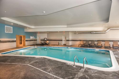 a large pool in a hotel room with chairs around it at Holiday Inn Hotel & Suites - Joliet Southwest by IHG in Joliet
