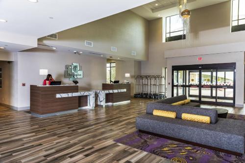 a lobby with a couch and a bar at Holiday Inn Hotel & Suites - Joliet Southwest, an IHG Hotel in Joliet