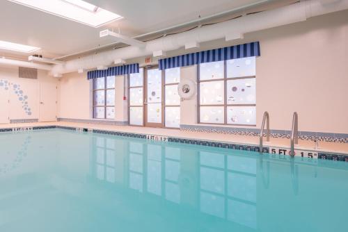 a large swimming pool in a room with a large window at Holiday Inn Express Cambridge by IHG in Cambridge