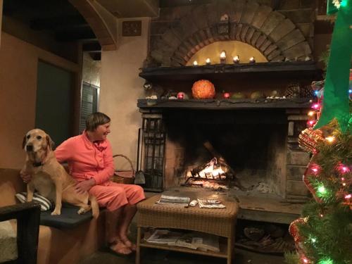 a man sitting in a living room next to a fire place at Les Artistes Inn in San Diego