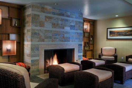 a lobby with chairs and a fireplace in a room at Hotel Indigo San Diego Del Mar by IHG in San Diego