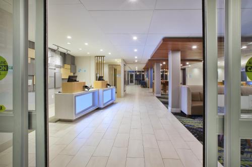 a hallway of an office building with a lobby at Holiday Inn Express & Suites Grand Rapids Airport North by IHG in Grand Rapids