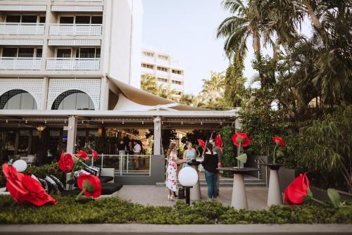 a group of people standing in front of a building at Cairns Harbourside Hotel in Cairns
