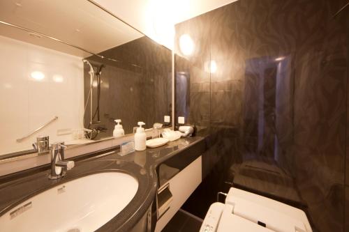 a bathroom with a sink and a large mirror at ANA Crowne Plaza Hotel Nagasaki Gloverhill, an IHG Hotel in Nagasaki