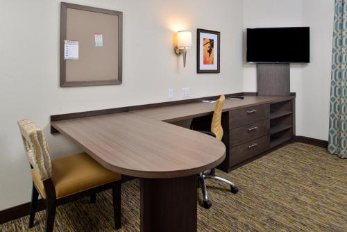 a hotel room with a desk and a television at Candlewood Suites - Lodi by IHG in Lodi