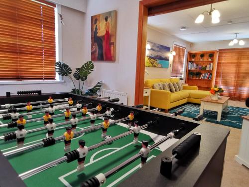 a living room with a pool table and toy players at Macadamia Retreat - City Central Hygge in Rotorua