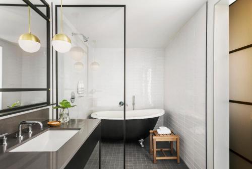 a bathroom with a tub and a sink at Kimpton Everly Hotel Hollywood by IHG in Los Angeles