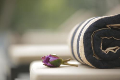 a small purple flower sitting on top of a roll at Miracle Resorts & Villas in Polonnaruwa