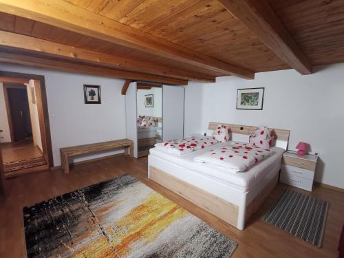 a bedroom with two beds and a wooden ceiling at Apart Ponholz in Hart im Zillertal
