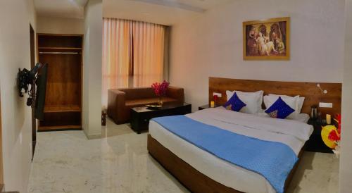 a bedroom with a large bed and a couch at The Jawai Gateway in Sheoganj