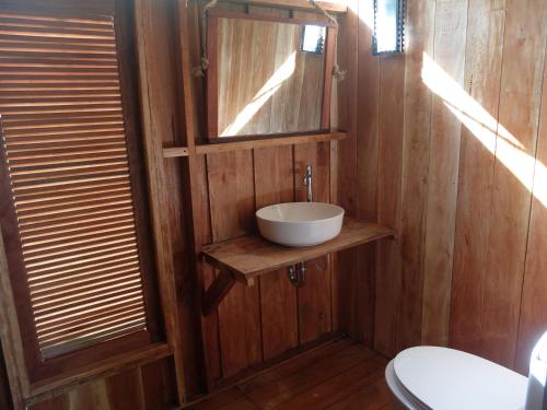 a bathroom with a sink and a mirror and a toilet at The Tropical Koh Mook in Koh Mook