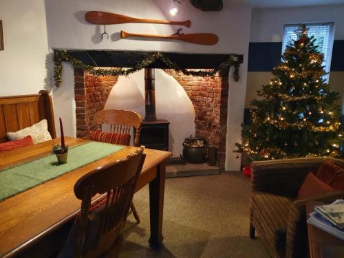 a living room with a christmas tree and a table at The Poop Deck in Upton upon Severn