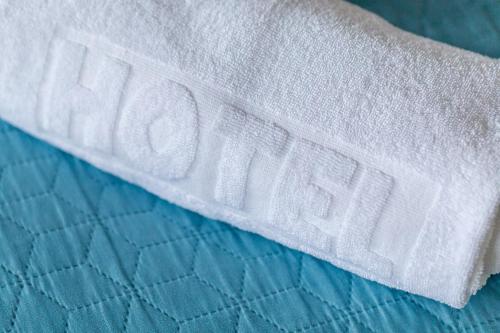 a white towel sitting on top of a bed at Szymonówka W Szklarskiej Porębie in Szklarska Poręba