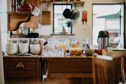 a kitchen with a counter with some food and drinks at The Village Lodge in Stormsrivier