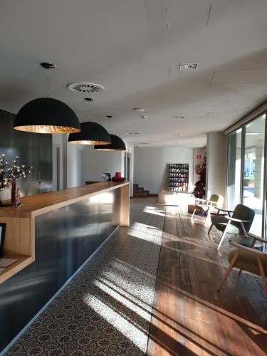 a living room with a bar and a table and chairs at Arrels d'Emporda in Palafrugell