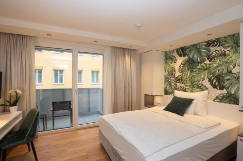 a bedroom with a large bed with a large painting on the wall at Wilmas Apartments by Arbio in Vienna