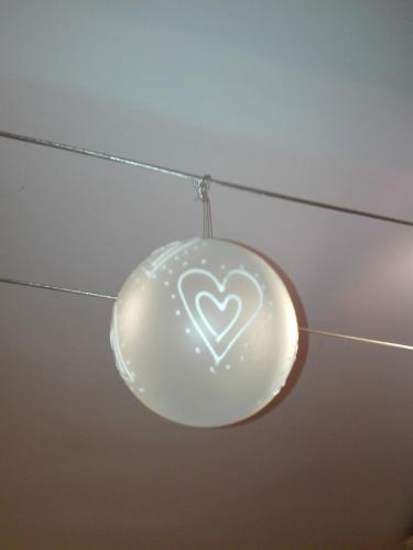 a glass heart ornament hanging from a ceiling at Sally's House in Venaria Reale