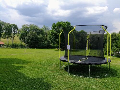a trampoline in a grassy field at Holiday Raj in Bešeňová