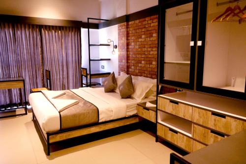 a bedroom with a bed in a room with a window at Vits Select Kudro Destinn in Mangalore