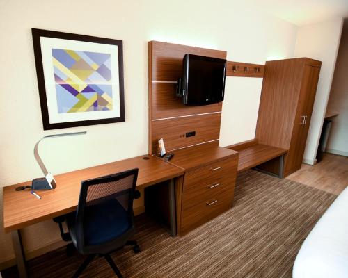 a hotel room with a desk and a tv at Holiday Inn Express Hotel & Suites Port Clinton-Catawba Island by IHG in Port Clinton