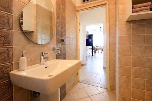 a bathroom with a sink and a mirror at Apartment Vincent with beautiful sea view terrace in Klenovica