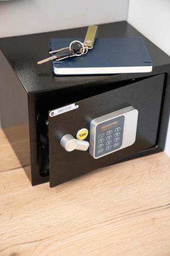 a black box with a remote control and a calculator at CHROMA FASHION ROOMS & APARTMENTS in Athens