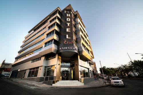 a building with a sign on the front of it at Nairoukh Hotel Aqaba in Aqaba