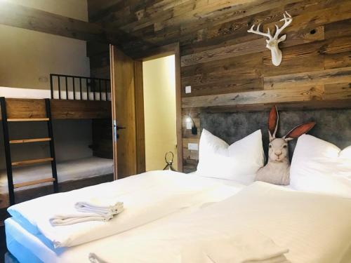 a bedroom with a bed with a deer head on the pillows at Sieglhub Chalets - Appartements - Hotel in Flachau