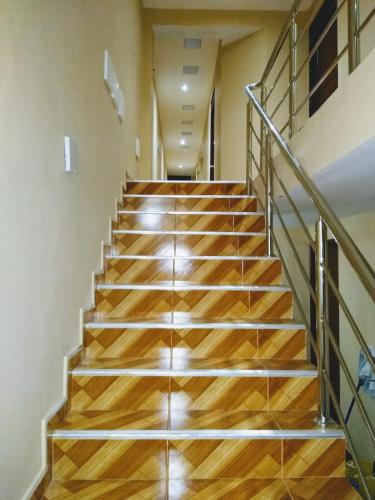 a staircase in a building with wooden floors and metal railings at D' Barrig in Trujillo